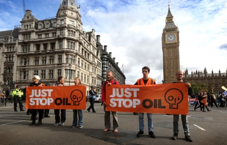 Supporters of Just Stop Oil (JSO) disrupt traffic as they block the road in the junction at Parliament Square in London on 3 October.