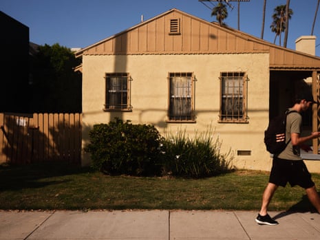 A pedestrian walks past a home