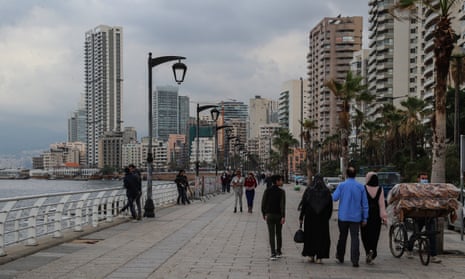 Citizens promenade on the seafront of the Mediterranean coast in Beirut during the curfew imposed by the government to fight the spread of the coronavirus.