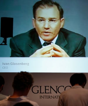 Journalists listen as Glencore CEO Ivan Glasenberg is broadcast on a screen during a teleconference in Hong Kong, in 2011.