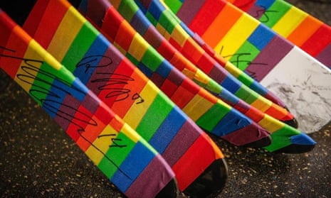 A close up shot of pride tape wrapped around ice hockey sticks.