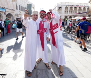 England fans pose for a photograph at a souk on the day of the Fifa World Cup Group B match against Wales in Doha, Qatar