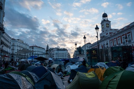 Lots of tents in a city square.
