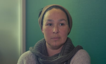 Portrait of woman with green wall behind