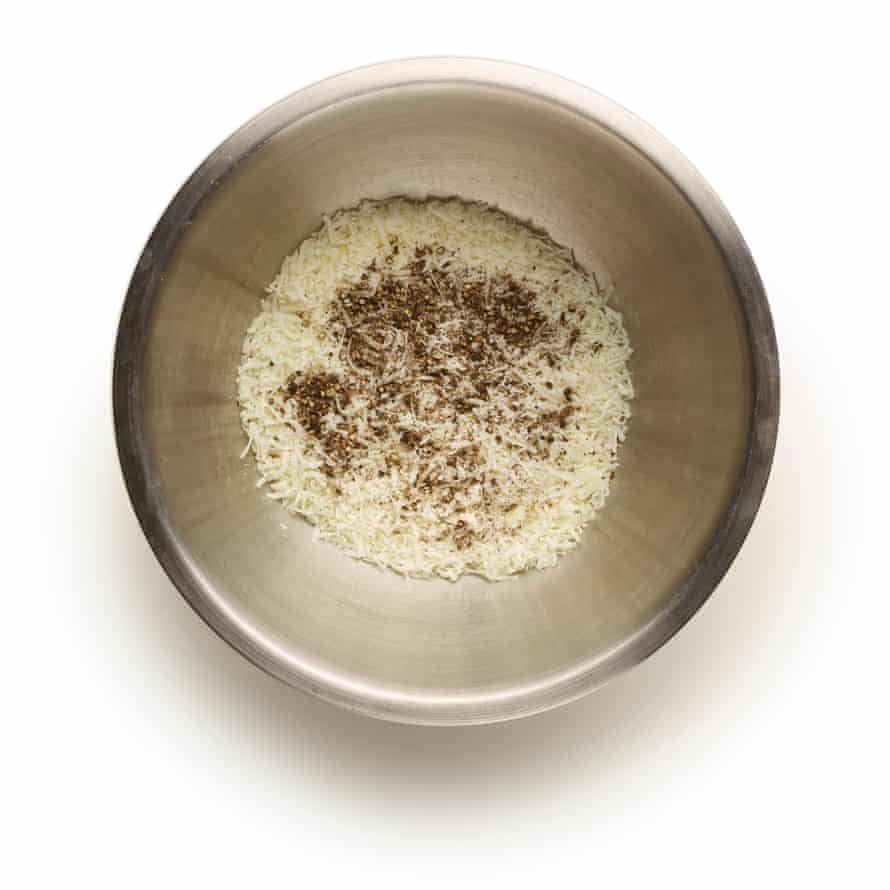 Some grated pecorino and pepper in a bowl.