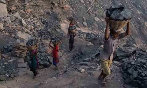 Villagers carry coal that has been scavenged illegally at one of Jharia’s many state-owned coal mines