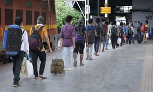 Migrant workers and stranded people are on queue for health check up and other activities by Indian Railway before leaving Howrah platform, 17 May 2020.