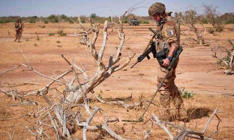 A French soldier searches for explosives in neighbouring Burkina Faso last month, where extremist groups have also increased their presence.