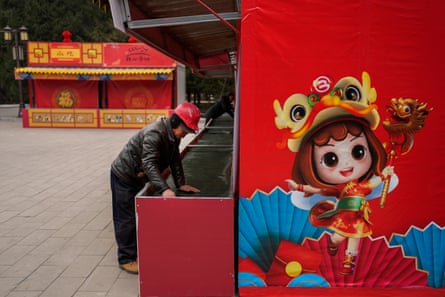 Workers set up stores for the temple fair ahead of the Chinese lunar new year at Ditan Park in Beijing on Sunday