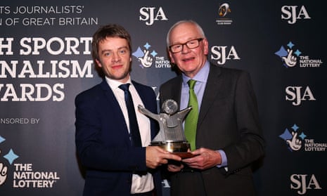 Daniel Taylor receives the sports writer of the year award from SJA president Patrick Collins.