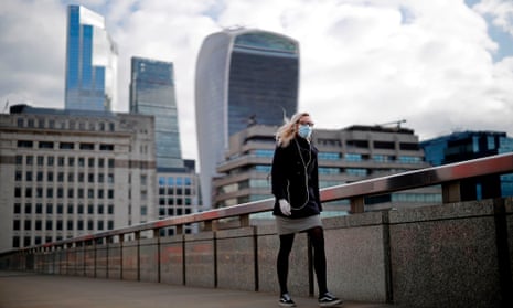 A woman walks across London Bridge