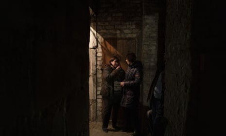 Women talk as they take shelter inside the basement of a residential building during a Russian attack in Lyman, Ukraine.
