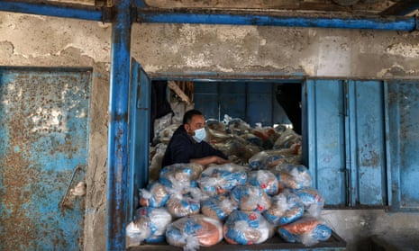 A Palestinian aid worker prepares food supplies at a UNRWA distribution centre in Gaza.