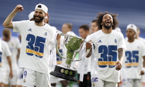 Karim Benzema (left) and Marcelo hold the league trophy after the game.