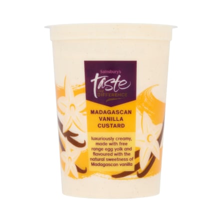 A plastic tub of Taste the Difference vanilla custard, labelled with vanilla flowers and swirls