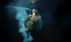 Heat 3, a man dives into an inky black sea, Bondi Beach.