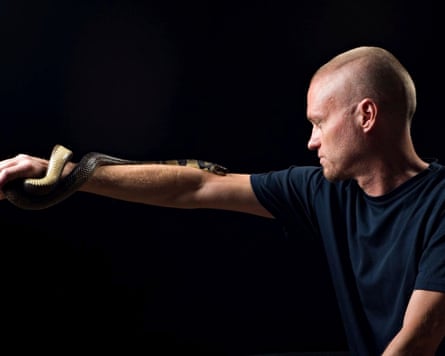 Tim Friede with a water cobra wrapped around his arm