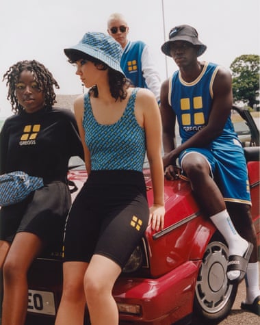 people sitting on car wearing clothes with Greggs logo