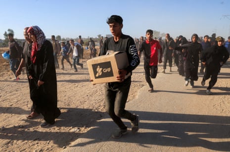 Palestinians receive aid from the U.S.-backed Gaza Humanitarian Foundation, in Khan Younis