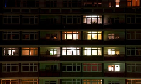 Windows in a block of flats lit up at night,