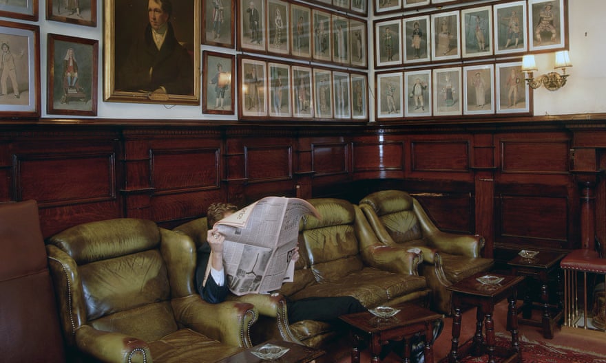 A member reading the paper in the lounge at the Garrick Club in London.