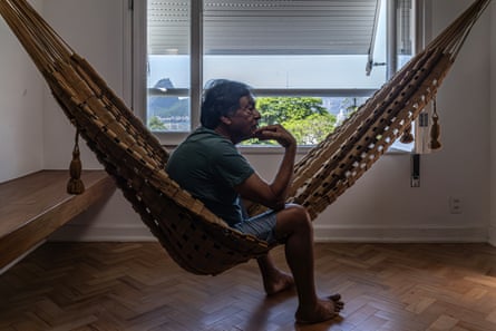 A man sits astride a hammock
