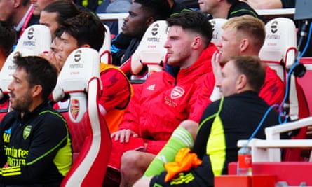Declan Rice looks on from the bench after going off with a back complaint at half-time on Sunday. Arsenal can ill afford to be without both him and Thomas Partey (behind) in midfield.