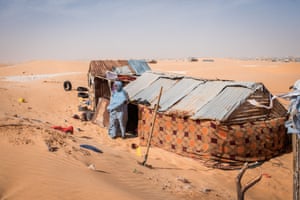 A Tarhil neighborhood resident outside her house