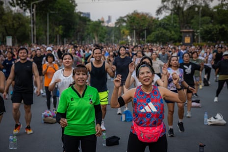Nawaporn Noppakun, in pink, dances with friends among a crowd