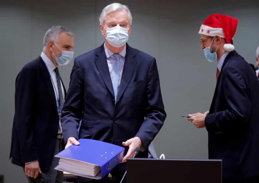 EU chief negotiator Michel Barnier holds the Brexit Trade deal document.