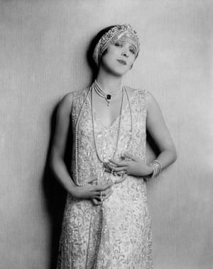 Opera singer Yvonne D’Arle, wearing a light sleeveless beaded sheath dress with jeweled sequin diadem, 1926.