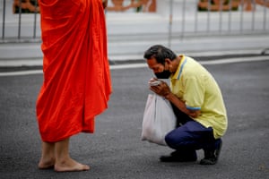 Bangkok, Thailand. Buddhist monks receive morning alms at the start of the Buddhist Lent, at Wat Benchamabophit, also known as the Marble Temple