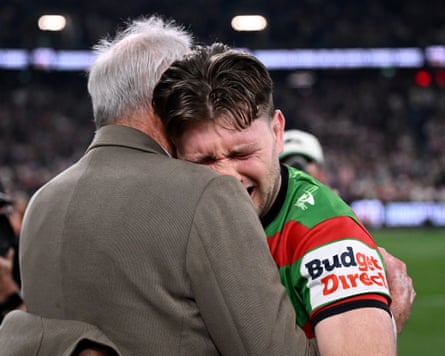 Jai Arrow is embraced by Rabbitohs coach Wayne Bennett after walking on to the field for his 100th NRL game for the club