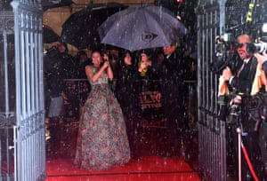 Gugu Mbatha-Raw shelters from the rain at the BFI London film festival awards