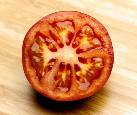 A tomato sliced in half, open side facing the camera