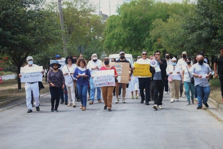 a group of people protesting and holding signs