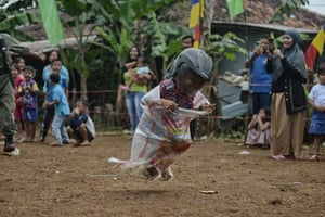 A child participates in a sack race game during celebrations for Indonesia’s 77th independence day in Bogor, West Java