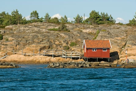 A small fishing hut overlooking a clear blue sea.