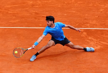 Carlos Alcaraz lunges to return a shot on the clay court in Monte Carlo