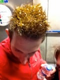A man with spiky hair sprayed gold