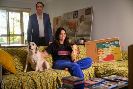 Creagh in her lounge room with the cutout, the ranking board and her beagle on the couch beside her