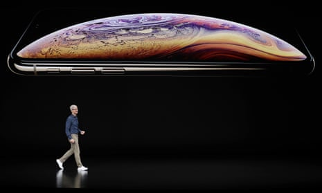 Apple’s CEO, Tim Cook, appears on stage in front of an image of the recently released iPhone XS.