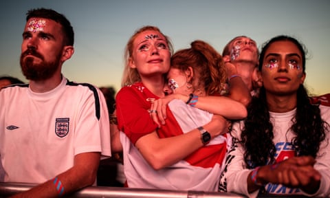 England football fans comfort each other in Hyde Park.