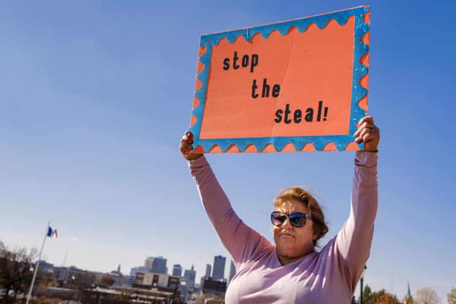 A woman holds up a sign at a pro-Trump rally in the Iowa capital on November 7 last year.