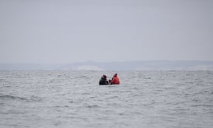 Migrants sit onboard a boat in the English Channel in August 2020.
