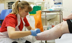 Lauren Brimble having her leg wound dressed by a nurse at St Woolos hospital.