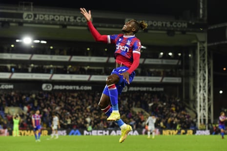 Wilfried Zaha leaps in the air after putting Crystal Palace 2-1 up against Wolves.