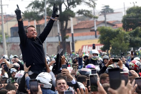 President Jair Bolsonaro reacts with supporters during in a motorcade rally as part of a re-election campaign in Sorocaba, Brazil on Tuesday in Sorocaba, Brazil.