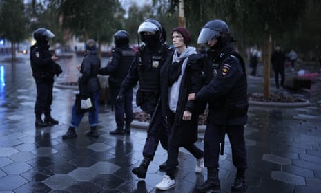 Police officers detain a demonstrator during a protest against a partial mobilisation in Moscow, Russia.