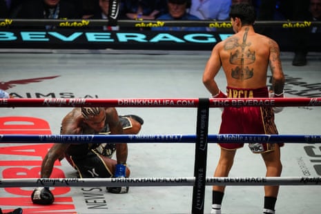 Ryan Garcia knocks down Conor Benn during their WBC welterweight title fight.
